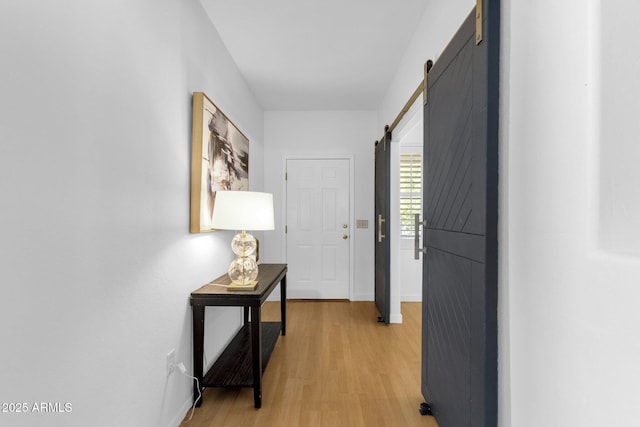 2545 E Harrison Ct, Gilbert, AZ 85295 - hallway featuring light wood-style floors and a barn door