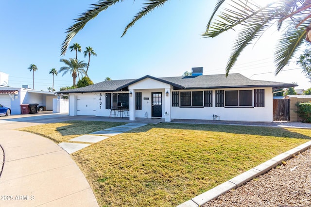 single story home with a garage and a front lawn