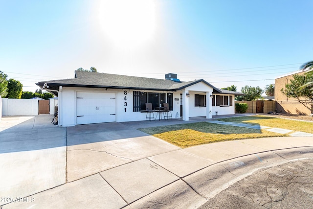 single story home with a front lawn and a garage