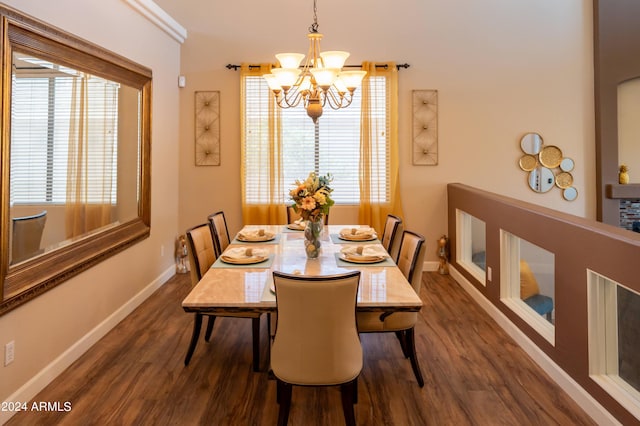 dining space featuring dark hardwood / wood-style floors and a chandelier