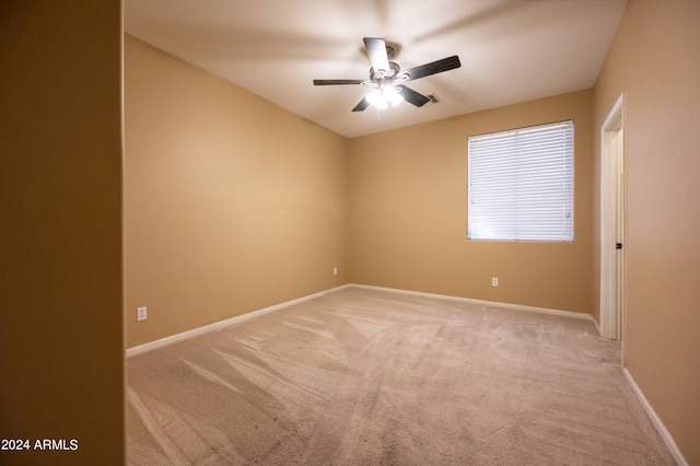 empty room featuring light colored carpet and ceiling fan