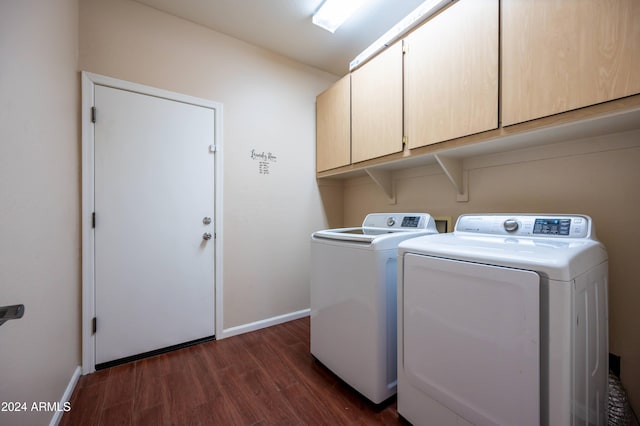 laundry room featuring cabinets, independent washer and dryer, and dark hardwood / wood-style flooring