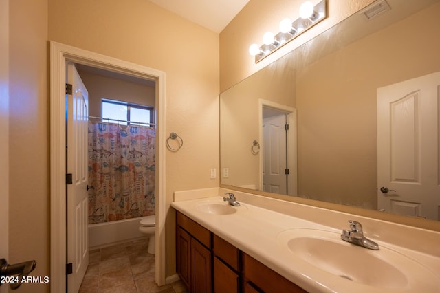 full bathroom with vanity, shower / bath combo with shower curtain, toilet, and tile patterned flooring