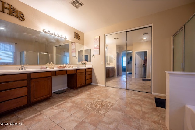 bathroom with vanity, tile patterned floors, and walk in shower