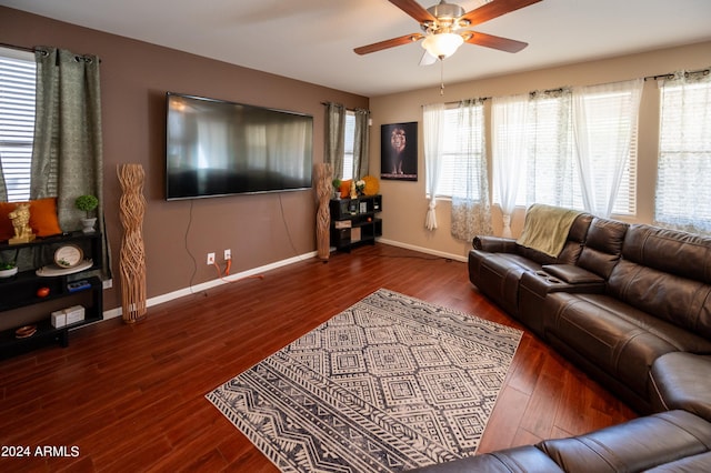 living room featuring ceiling fan and dark hardwood / wood-style flooring