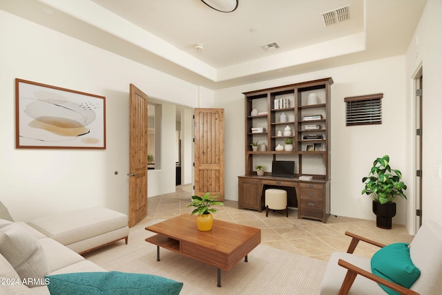 sitting room featuring light tile patterned floors and a raised ceiling