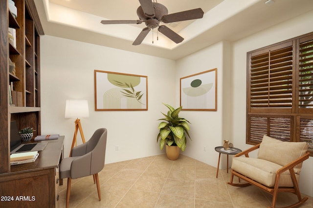 office area with light tile patterned floors and ceiling fan