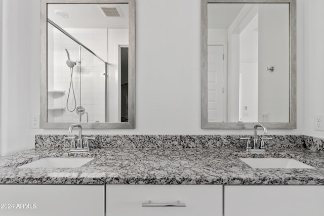 bathroom featuring vanity and a shower with door