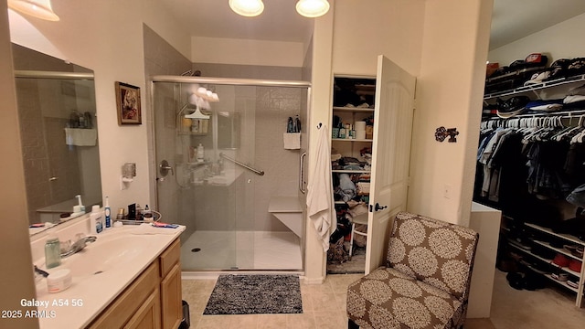 5708 E Sunrise Cir, Florence, AZ 85132 - bathroom with vanity, a shower stall, and a walk in closet