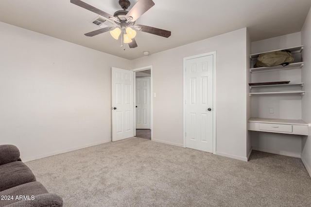 unfurnished bedroom featuring ceiling fan and light colored carpet