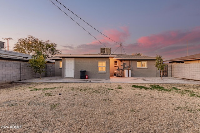 view of front of property with a patio area and central AC