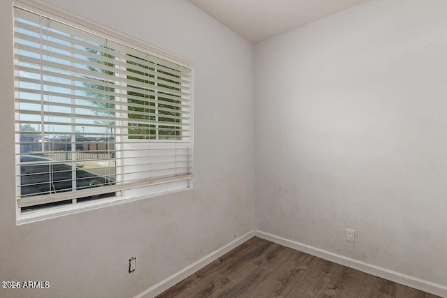 spare room featuring dark wood-type flooring