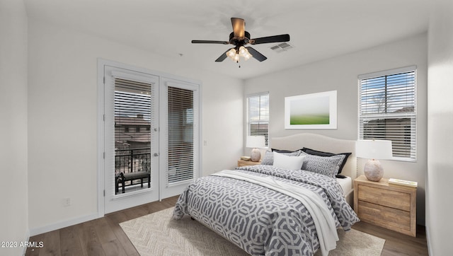 bedroom featuring multiple windows, ceiling fan, hardwood / wood-style floors, and access to outside