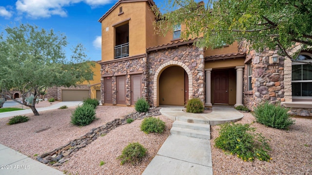 view of front of home featuring a balcony and a garage