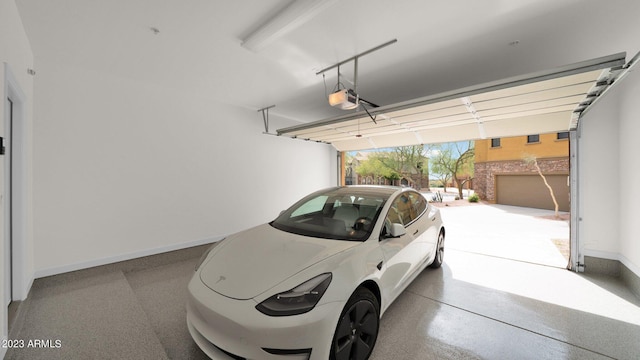 garage with a garage door opener and baseboards