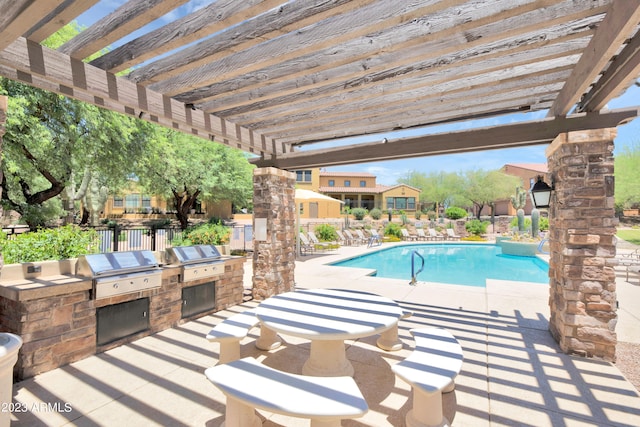 view of swimming pool with a pergola, exterior kitchen, a patio, and grilling area