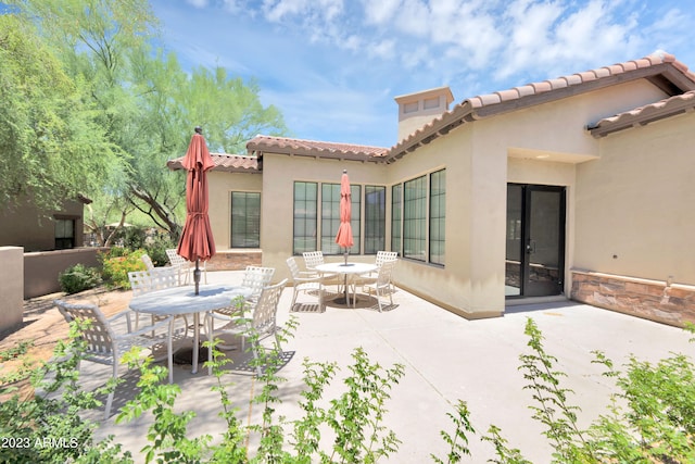 rear view of house featuring a patio