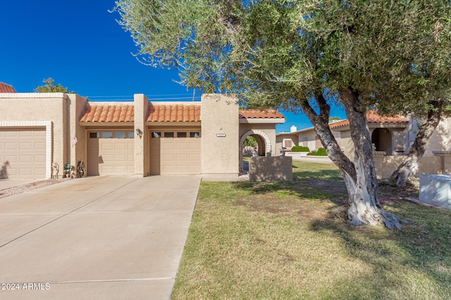 view of front facade with a front lawn and a garage