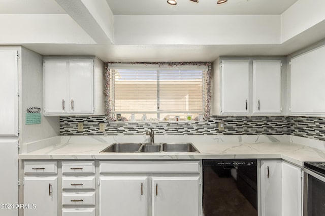 kitchen featuring white cabinetry, sink, light stone counters, decorative backsplash, and black dishwasher