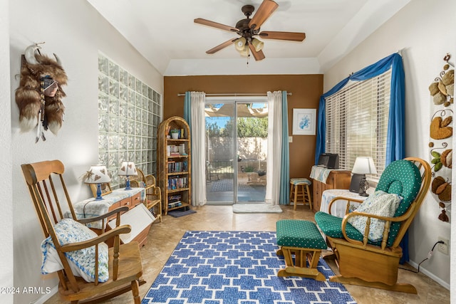 living area with light tile patterned floors and ceiling fan