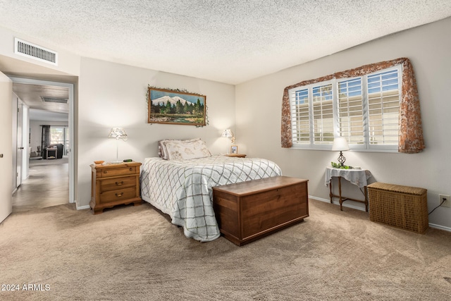 carpeted bedroom featuring a textured ceiling