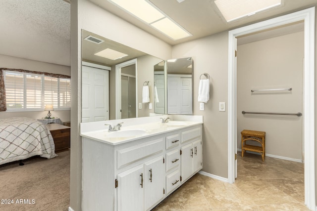 bathroom featuring vanity and a textured ceiling