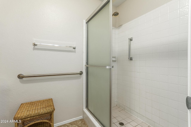 bathroom featuring walk in shower and tile patterned flooring