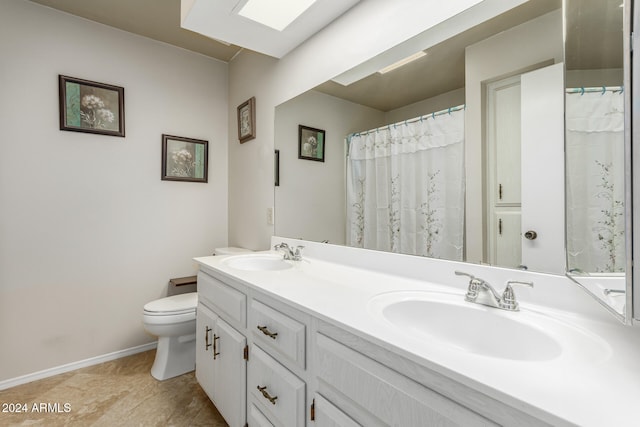 bathroom featuring toilet and vanity