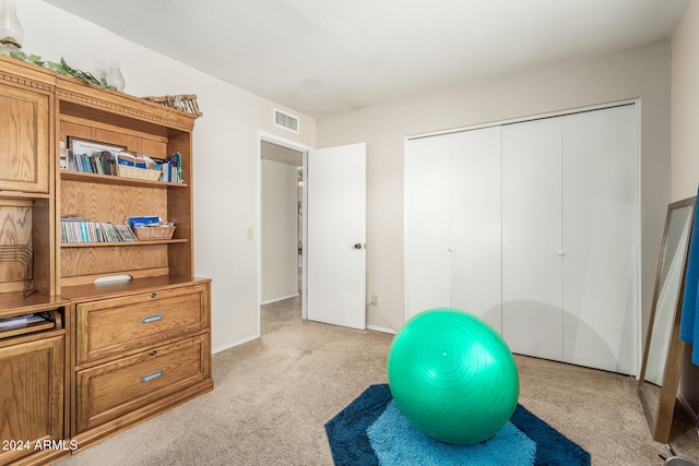 exercise room with light carpet