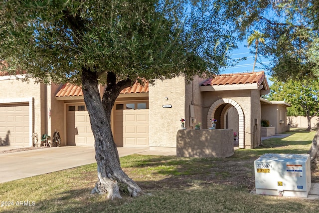 mediterranean / spanish-style home with a garage