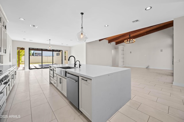 kitchen with a sink, stainless steel dishwasher, open floor plan, and recessed lighting