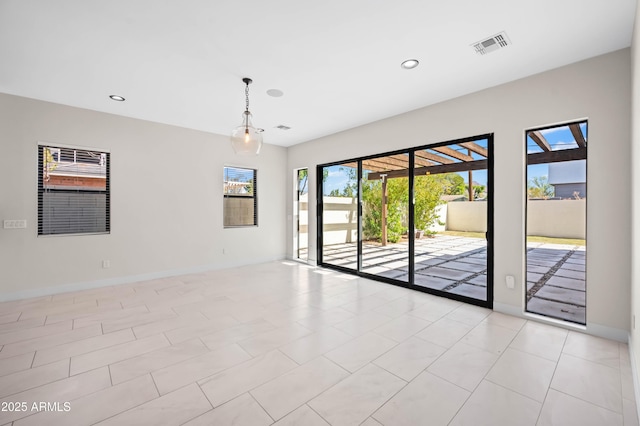 spare room featuring visible vents, recessed lighting, and baseboards