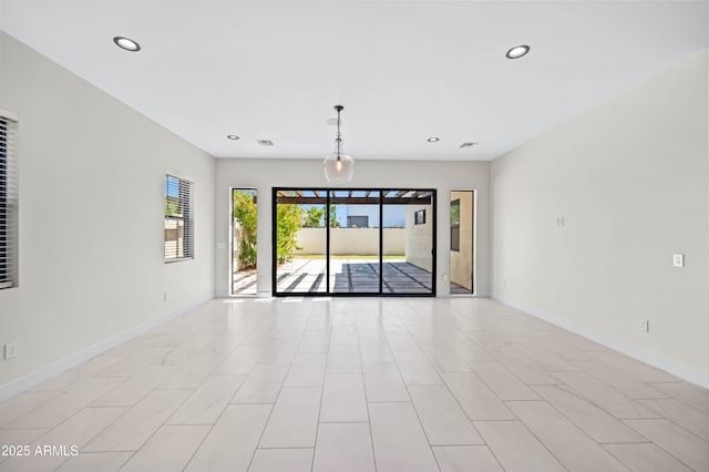 spare room with visible vents, recessed lighting, and baseboards