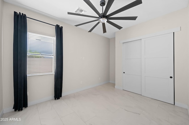 unfurnished bedroom featuring visible vents, baseboards, a closet, and ceiling fan