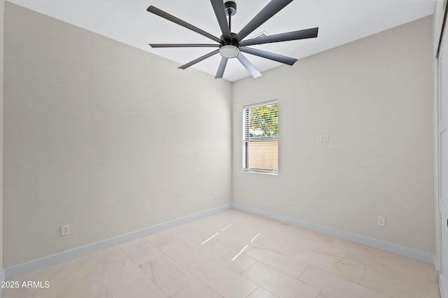 spare room featuring baseboards and ceiling fan