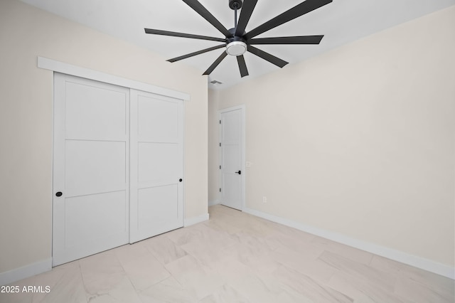 unfurnished bedroom with a ceiling fan, visible vents, baseboards, and a closet