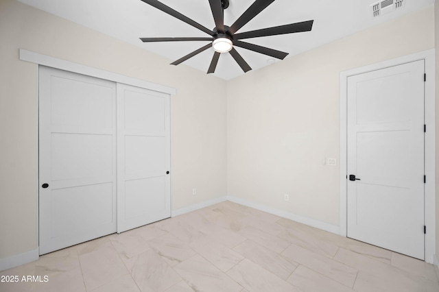 unfurnished bedroom featuring a ceiling fan, baseboards, visible vents, and a closet