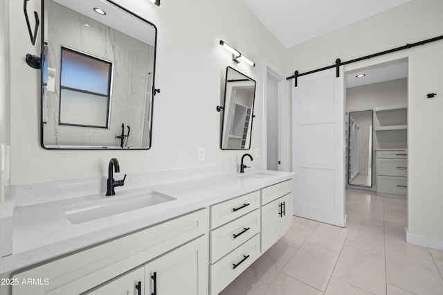 full bath featuring a sink, double vanity, and tile patterned flooring