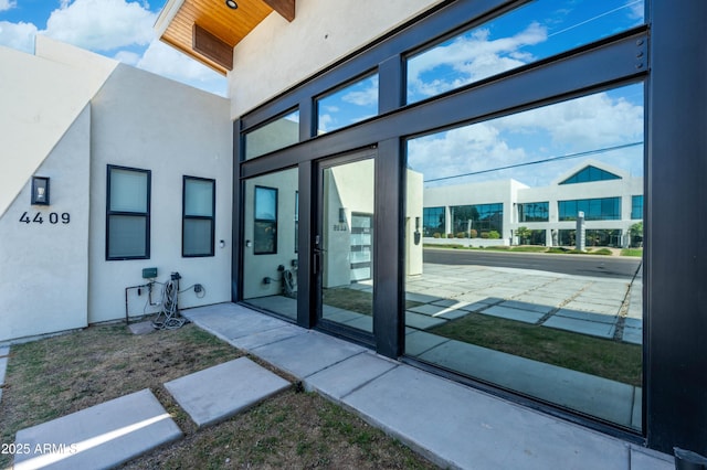 property entrance with stucco siding