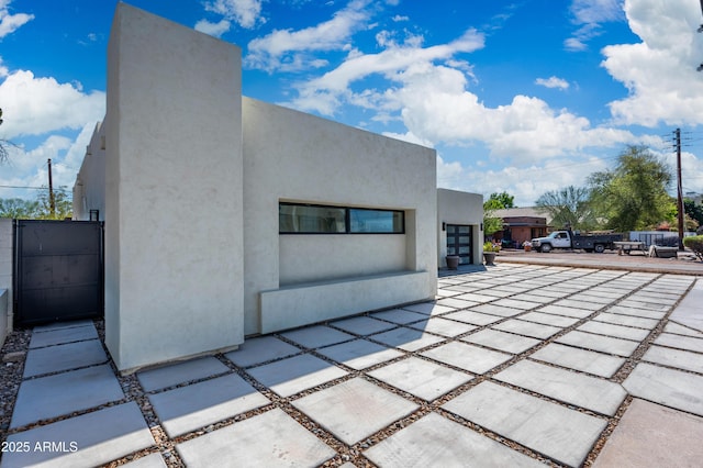 back of property featuring stucco siding