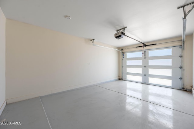 garage with a garage door opener and baseboards