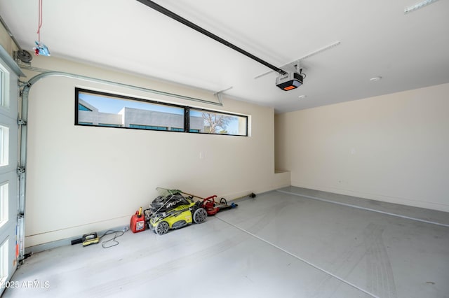 garage with a garage door opener and baseboards