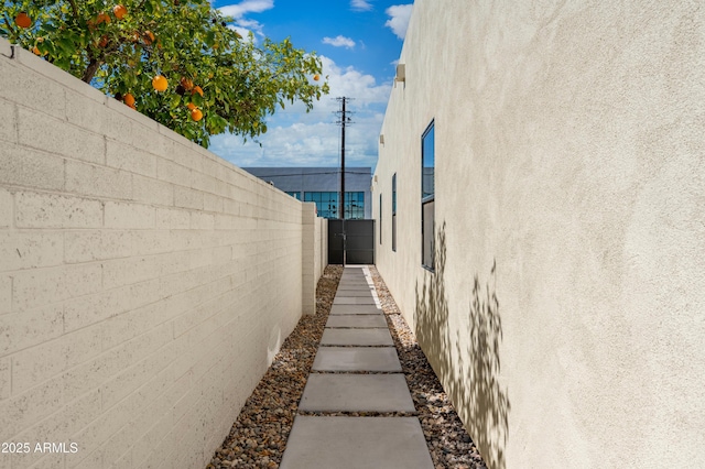 view of property exterior with fence and stucco siding