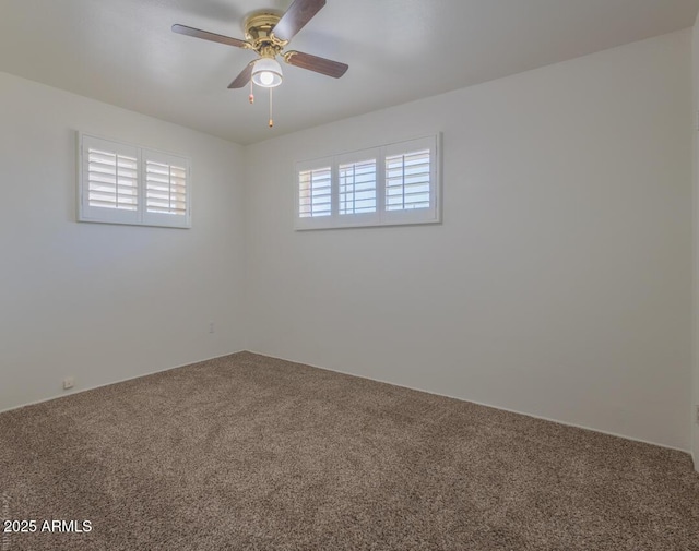 unfurnished room with ceiling fan, a healthy amount of sunlight, and carpet floors