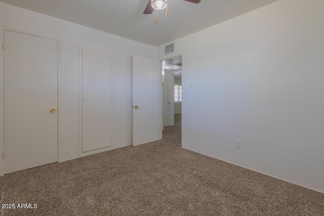 unfurnished bedroom featuring ceiling fan and carpet