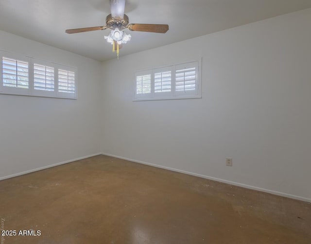 spare room with plenty of natural light and concrete flooring