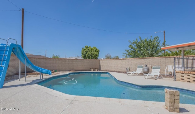 view of pool featuring a patio area and a water slide