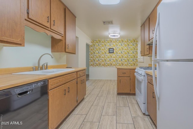 kitchen featuring light hardwood / wood-style floors, white appliances, and sink