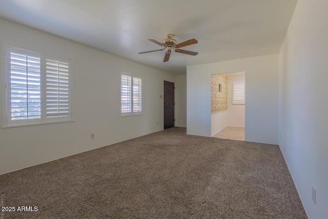 carpeted empty room with ceiling fan