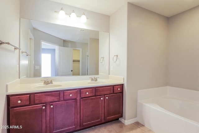 24479 W Mobile Ln, Buckeye, AZ 85326 - full bathroom featuring double vanity, a garden tub, tile patterned floors, and a sink